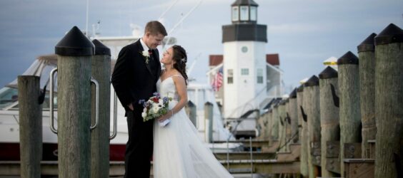 bride and groom standing on pier